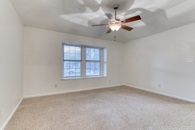 carpeted empty room featuring a textured ceiling and ceiling fan