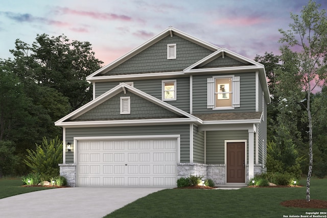 craftsman-style home featuring a yard and a garage