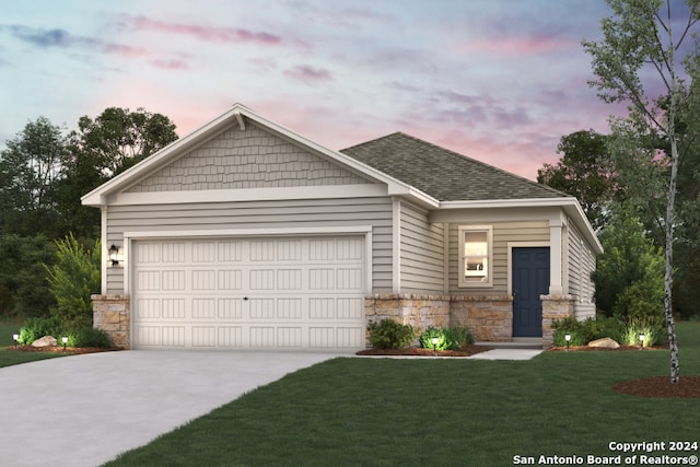 view of front of home featuring a garage and a yard