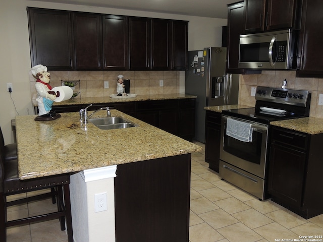 kitchen with appliances with stainless steel finishes, backsplash, and light stone countertops