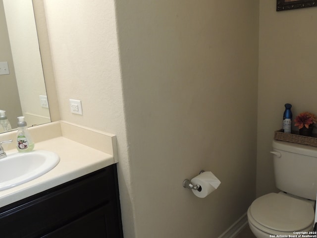 bathroom with toilet and vanity