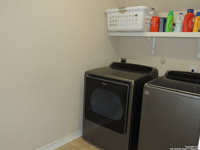 laundry room featuring independent washer and dryer and light tile patterned flooring