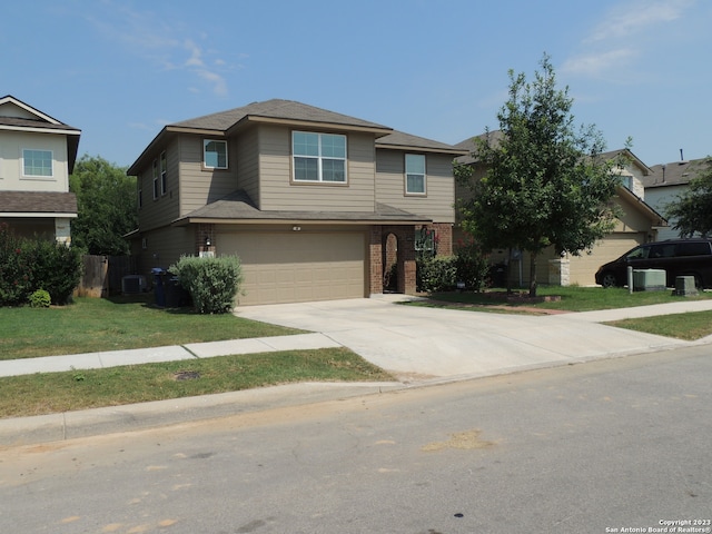 view of front of home featuring cooling unit and a garage