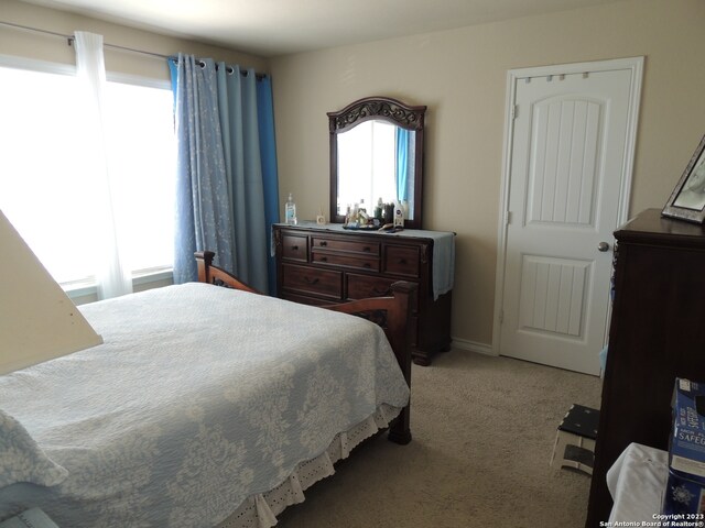 bedroom with light colored carpet