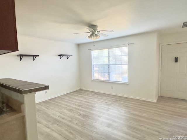 unfurnished room with ceiling fan and light hardwood / wood-style flooring