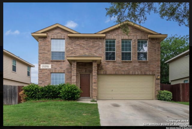 view of front of property featuring a garage and a front lawn