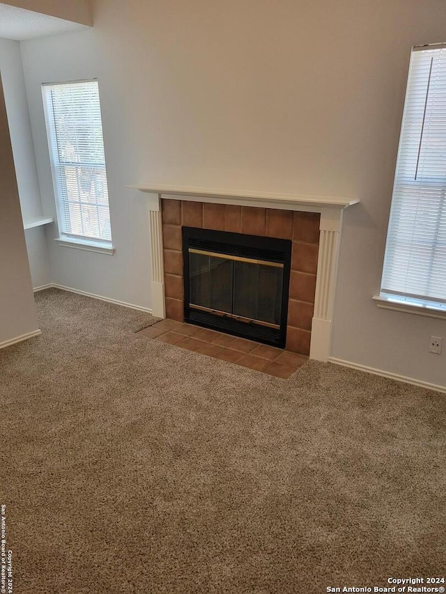 details with carpet floors and a tiled fireplace