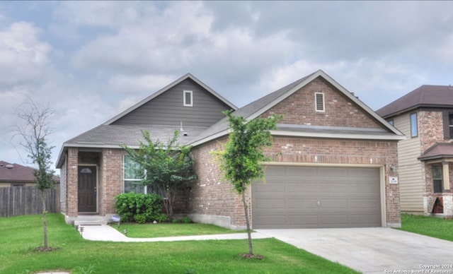 view of front of property with a garage and a front lawn