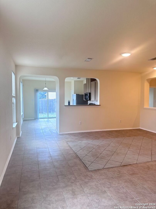 unfurnished living room featuring light tile patterned floors