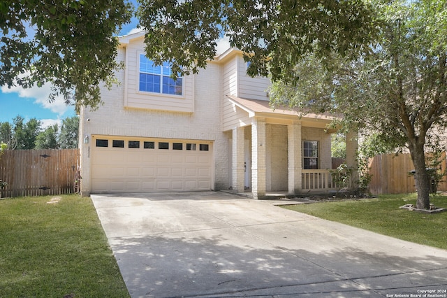 view of front of property featuring a garage and a front yard