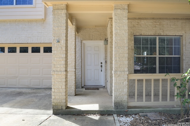 view of exterior entry with a garage