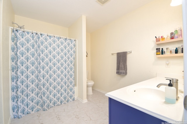 bathroom featuring tile patterned floors, toilet, and vanity