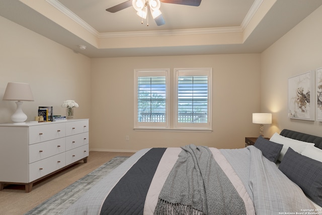 bedroom with ceiling fan, carpet flooring, crown molding, and a tray ceiling