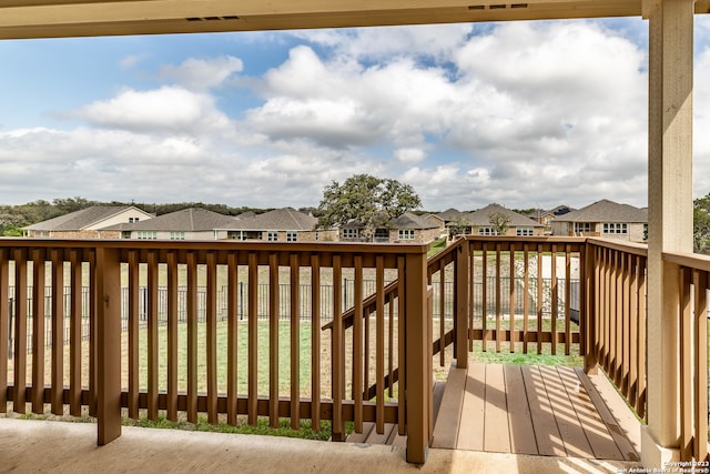 wooden deck featuring a lawn