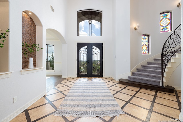 entryway featuring french doors and a high ceiling