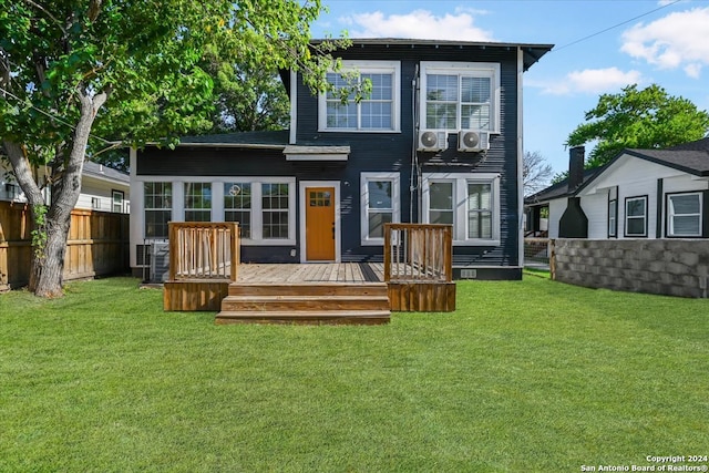 rear view of house with a yard and a deck