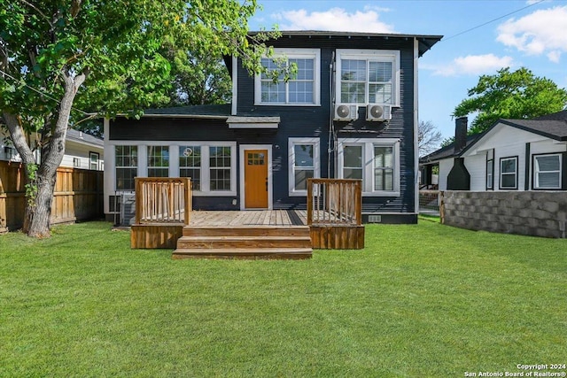 back of house with a yard, fence, and a deck