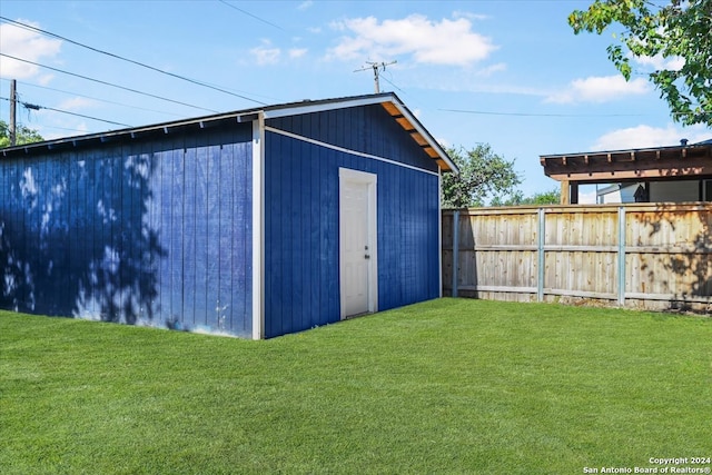 view of outbuilding featuring a lawn