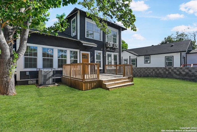 back of house featuring a deck, central AC, and a yard