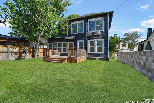 back of property featuring a deck and a lawn