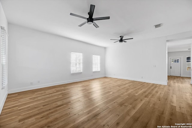 unfurnished living room featuring ceiling fan and light hardwood / wood-style flooring