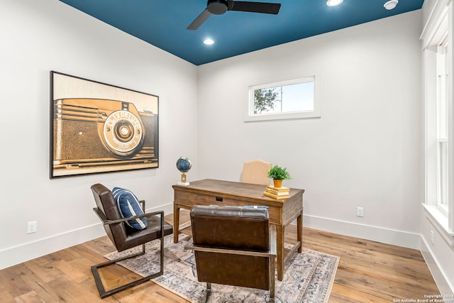 home office with ceiling fan and light hardwood / wood-style flooring