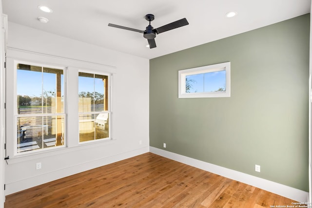 empty room featuring ceiling fan and light hardwood / wood-style flooring