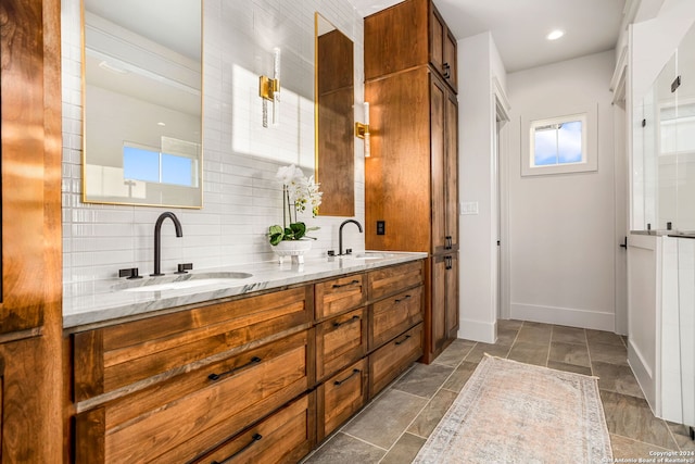 bathroom featuring decorative backsplash, dual vanity, and tile patterned floors