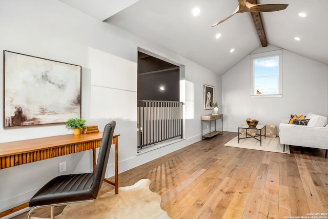 home office featuring ceiling fan, vaulted ceiling with beams, and light wood-type flooring