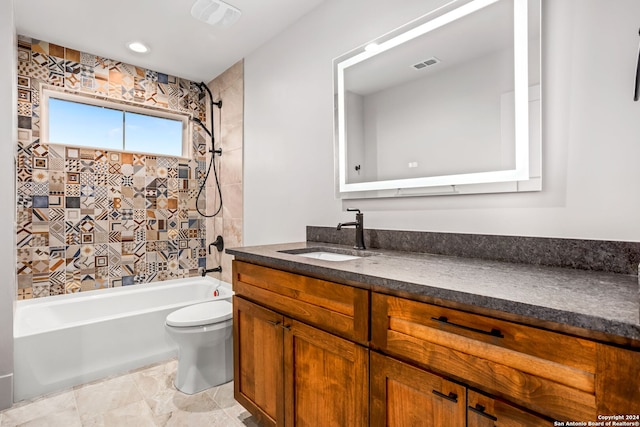 full bathroom featuring toilet, tiled shower / bath combo, vanity, and tile patterned floors