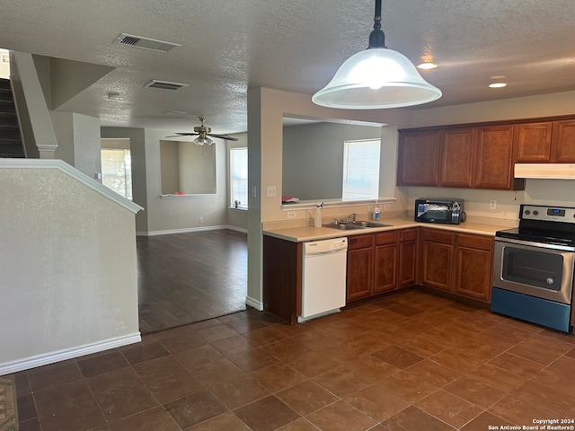 kitchen featuring dark tile patterned floors, stainless steel electric range, dishwasher, and a healthy amount of sunlight