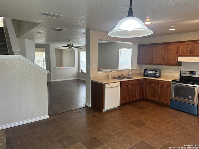 kitchen featuring pendant lighting, stainless steel electric stove, light countertops, a sink, and dishwasher