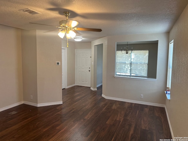 spare room featuring a textured ceiling, ceiling fan with notable chandelier, and hardwood / wood-style flooring