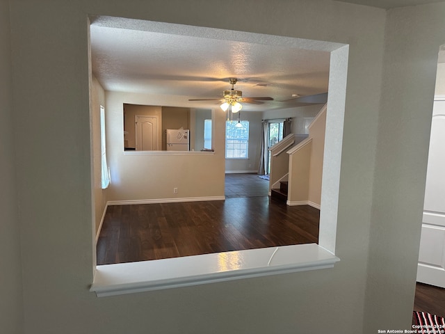 unfurnished room with ceiling fan, hardwood / wood-style flooring, and a textured ceiling