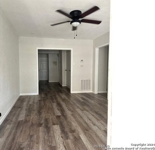 empty room with ceiling fan and wood-type flooring