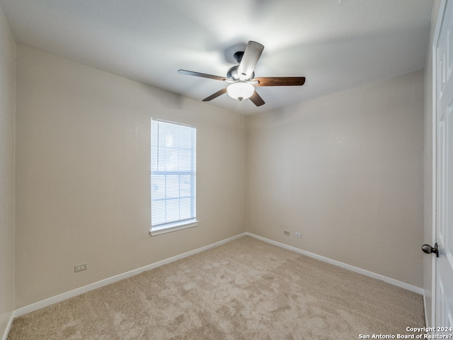 unfurnished room with ceiling fan and light colored carpet