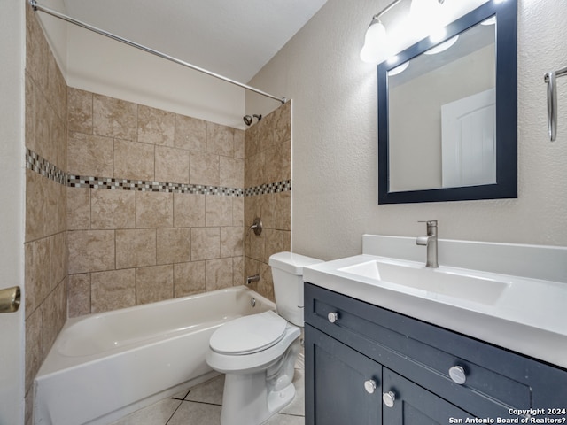 full bathroom featuring toilet, tiled shower / bath combo, vanity, and tile patterned floors