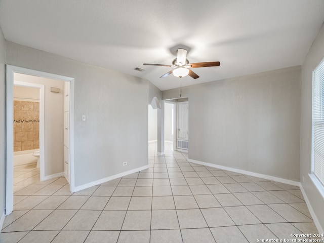 tiled empty room featuring ceiling fan