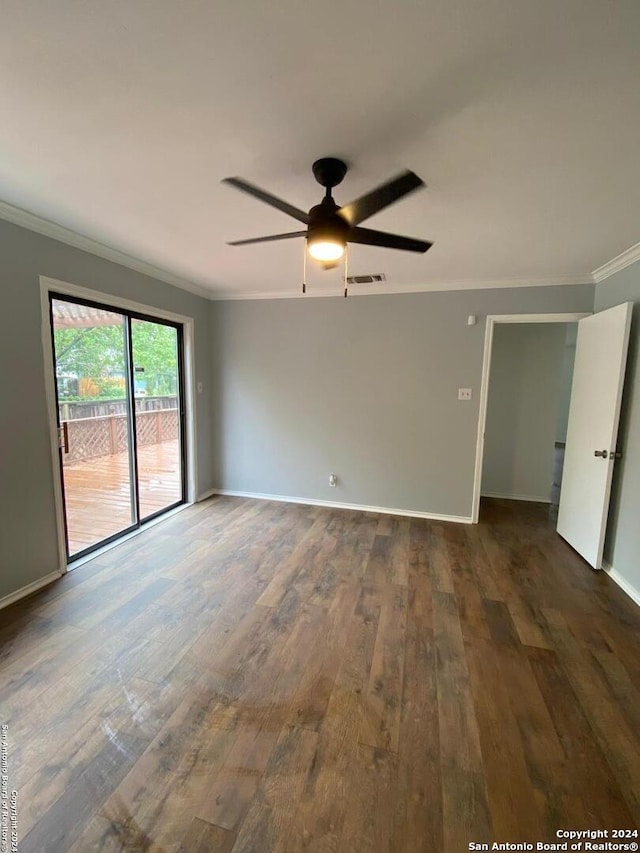 unfurnished bedroom with ceiling fan, access to exterior, dark wood-type flooring, and crown molding