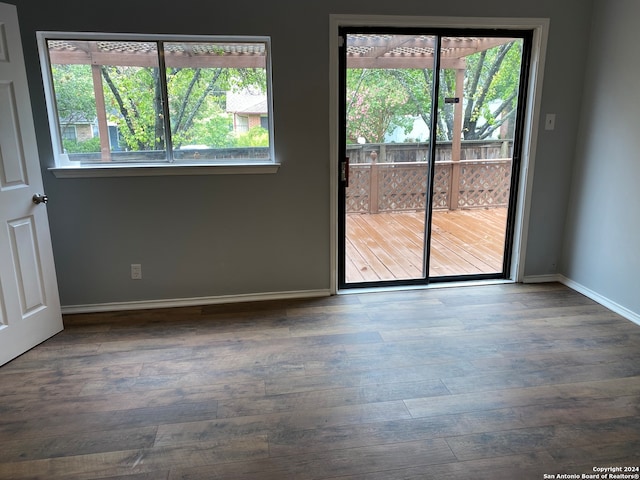 empty room with dark hardwood / wood-style floors