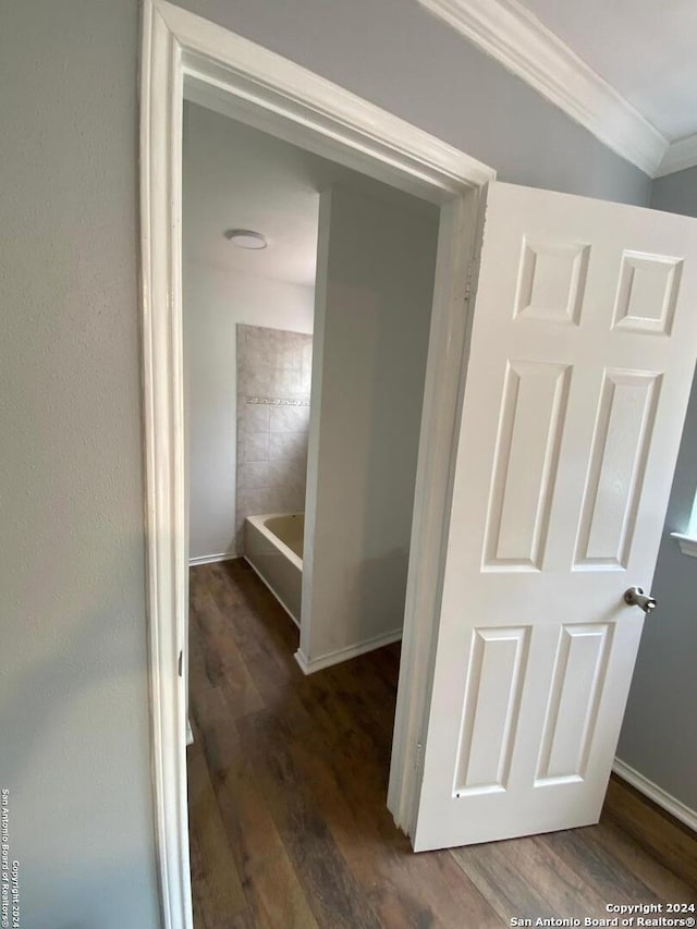 hall with crown molding and dark hardwood / wood-style flooring