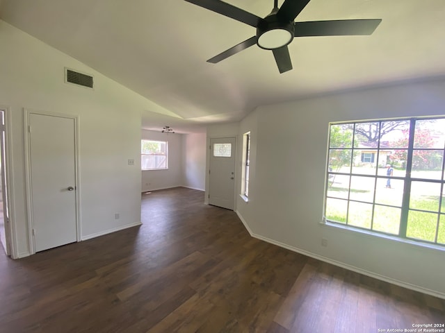 unfurnished room with lofted ceiling, ceiling fan, and dark hardwood / wood-style flooring