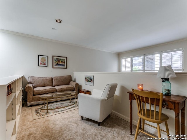 living room featuring ornamental molding, light colored carpet, and baseboards