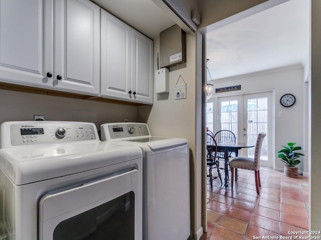 laundry room with light tile patterned floors, cabinet space, ornamental molding, washer and dryer, and baseboards