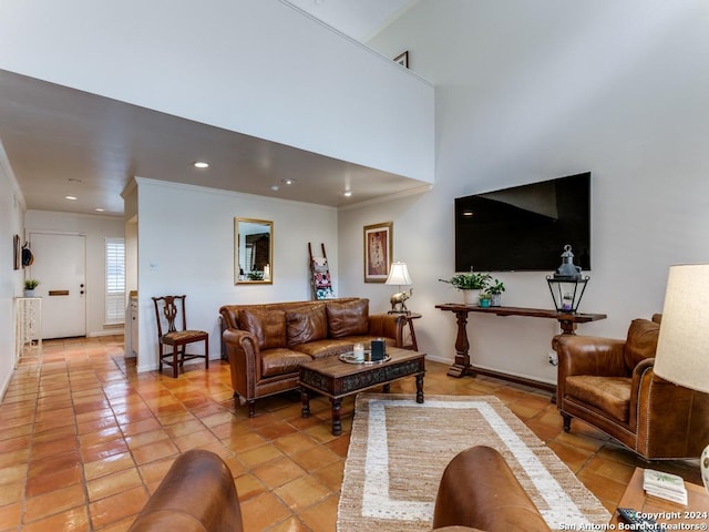 living area featuring light tile patterned floors, baseboards, crown molding, and recessed lighting