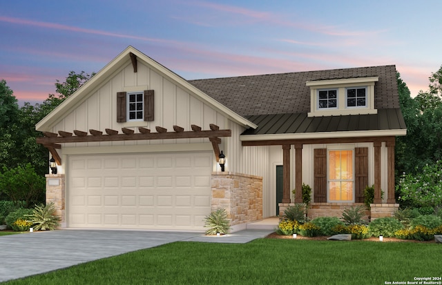 view of front of property with a garage and a yard