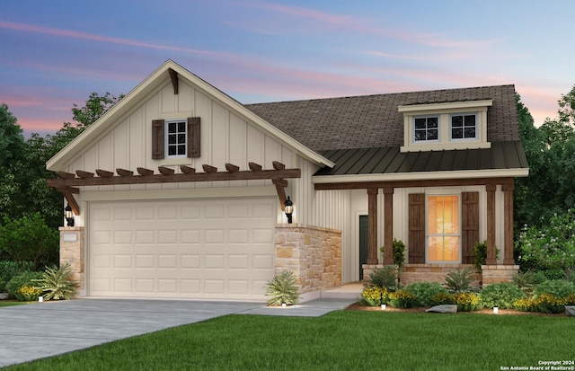 view of front of property featuring a garage, concrete driveway, board and batten siding, a standing seam roof, and a front yard