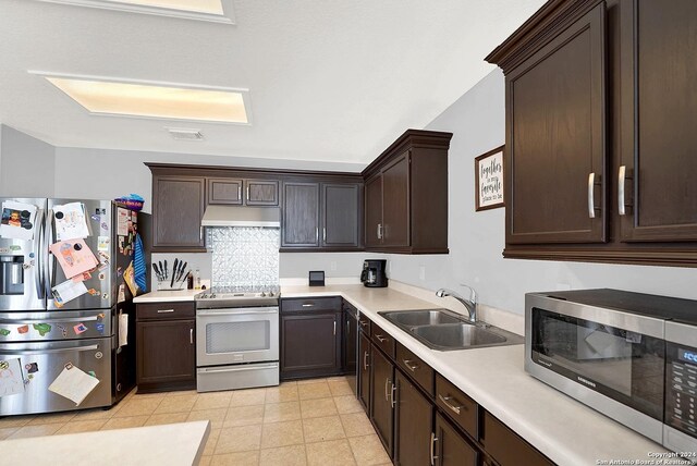 kitchen featuring light tile patterned floors, sink, stainless steel appliances, and dark brown cabinets