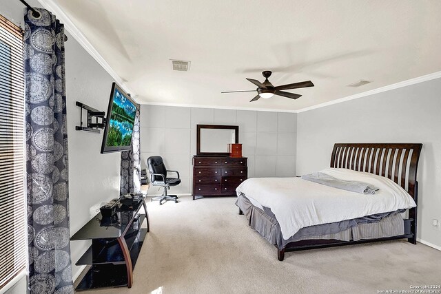 bedroom featuring ceiling fan, ornamental molding, and carpet flooring