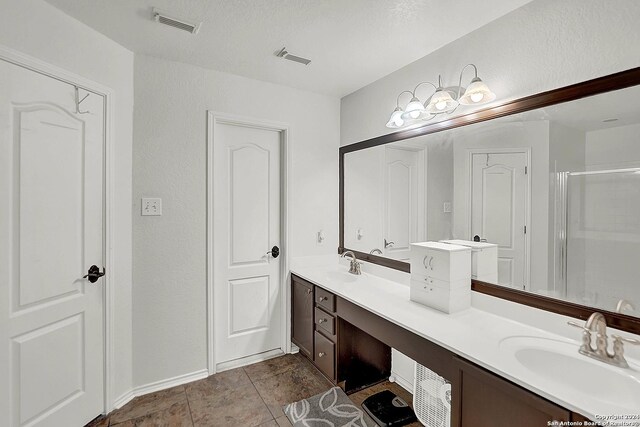 bathroom featuring tile patterned flooring and double sink vanity